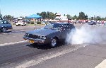 Gray 1986 Buick T-Type doing a burnout