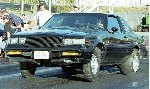 A 1987 Buick Grand National launching at the drag strip.  Check out those rear tires!